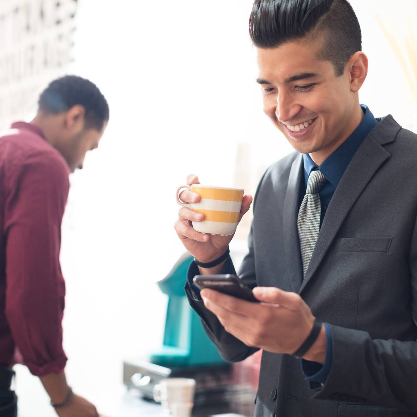 young-businessman-looking-at-smartphone-2022-03-04-01-51-31-utc (1)